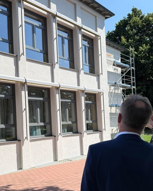 Robert Pötzsch betrachtet den neuen Anstrich der Fassade an der Grundschule an der Beethovenstraße